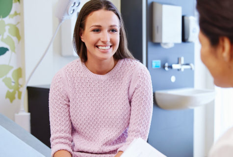 Young female patient smiling at a female staff member