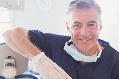 Middle-aged male dentist smiling